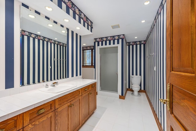 bathroom with vanity, toilet, and a shower