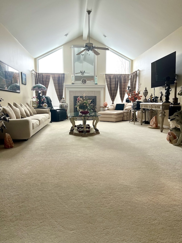 carpeted living room with a fireplace, high vaulted ceiling, and beamed ceiling