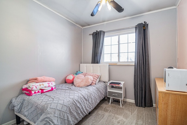 bedroom featuring carpet floors, ornamental molding, baseboards, and ceiling fan