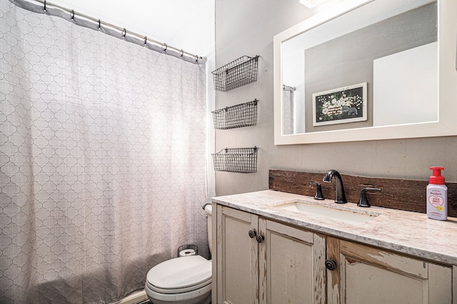 full bath featuring shower / bath combo, vanity, and toilet