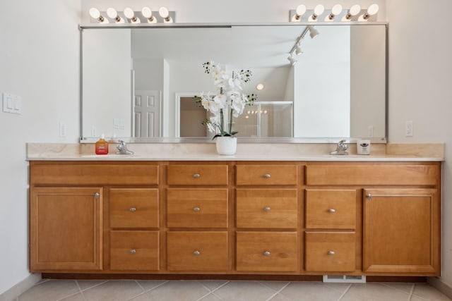 bathroom featuring vanity, tile patterned flooring, and a shower with door