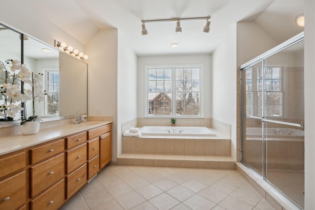 bathroom with vaulted ceiling, plus walk in shower, tile patterned flooring, and vanity