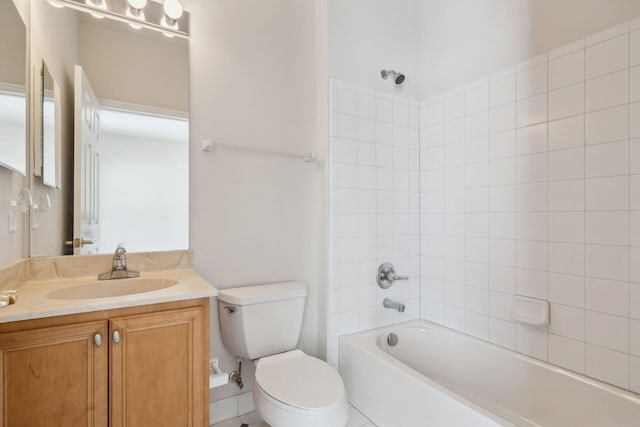 full bathroom featuring vanity, tiled shower / bath, and toilet