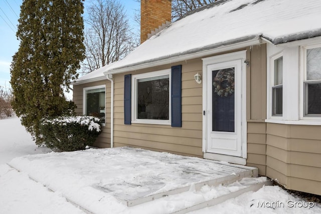 view of snow covered property entrance