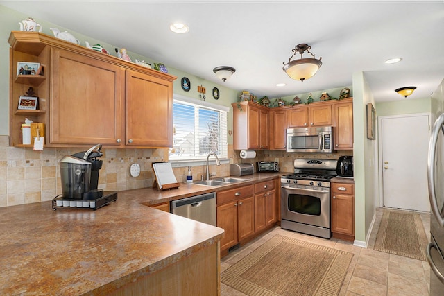 kitchen featuring appliances with stainless steel finishes, light tile patterned floors, sink, and tasteful backsplash