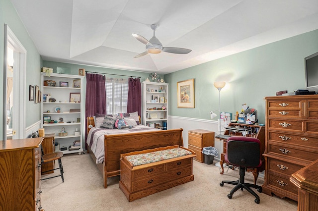 bedroom with a tray ceiling, ceiling fan, and light colored carpet