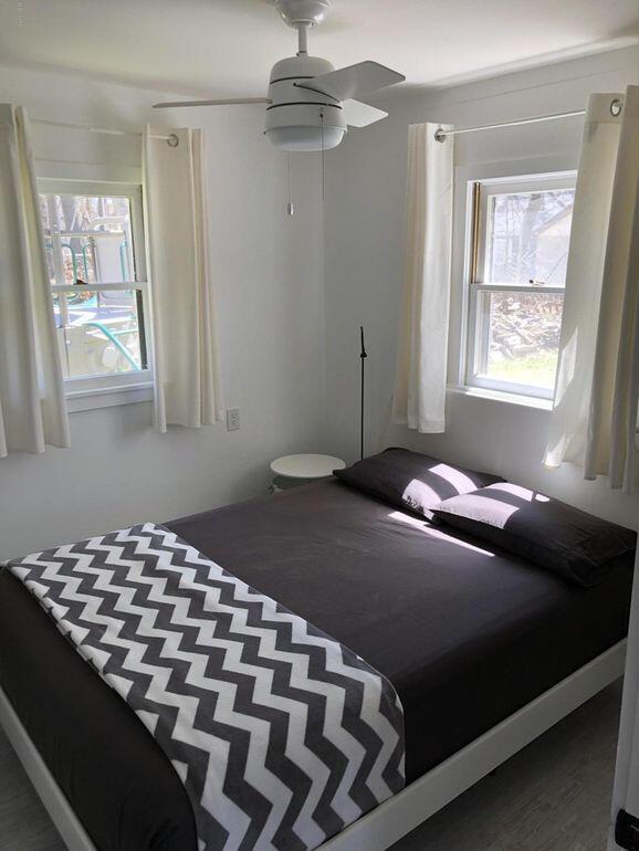 bedroom with ceiling fan and dark wood-type flooring