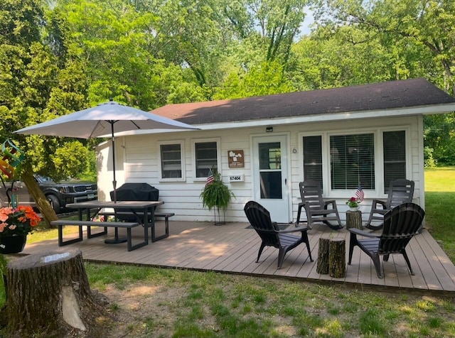 rear view of house with a wooden deck