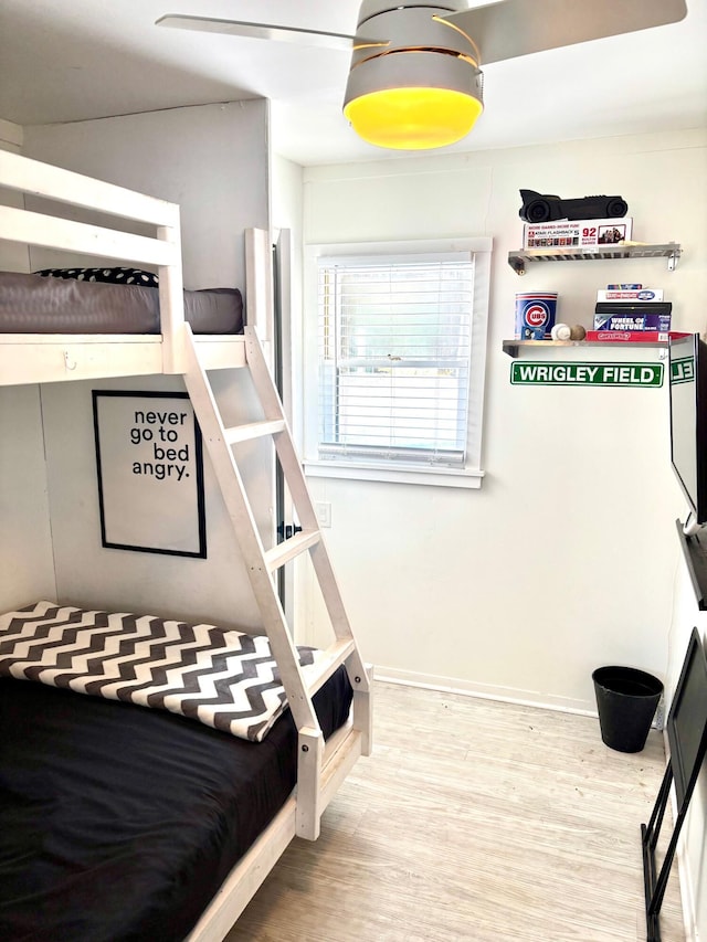 bedroom with baseboards and wood finished floors