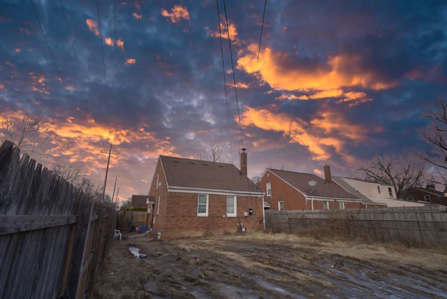 view of back house at dusk