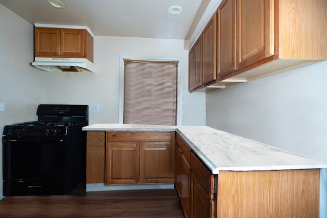 kitchen featuring dark wood-type flooring and black range with gas stovetop