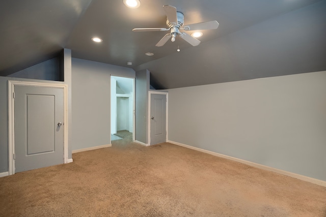 bonus room with lofted ceiling, light colored carpet, and ceiling fan