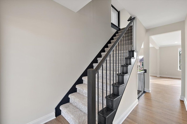 stairway with baseboards and wood finished floors