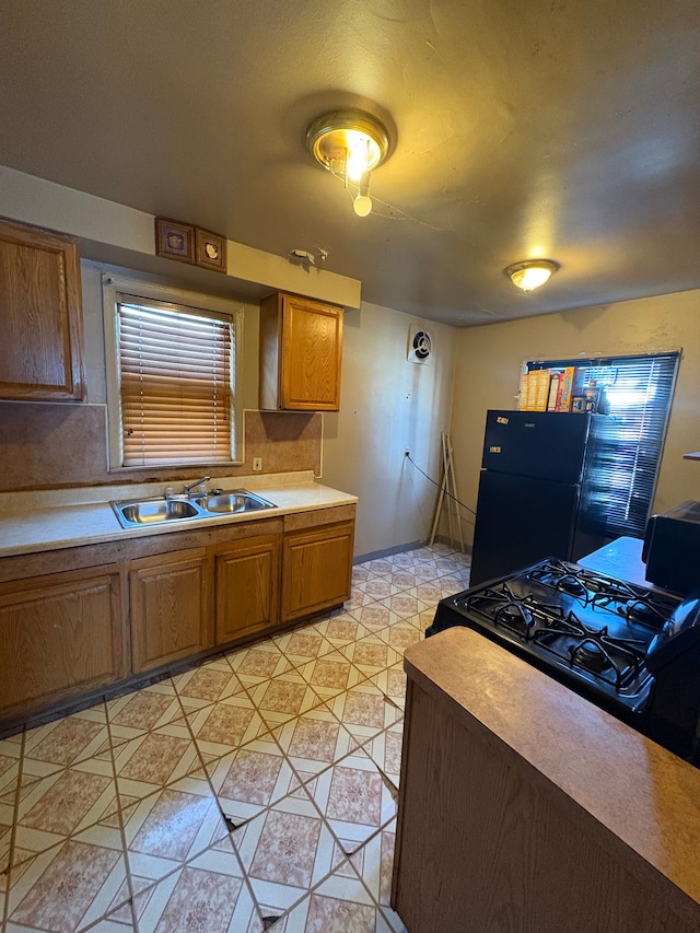 kitchen featuring sink and black appliances