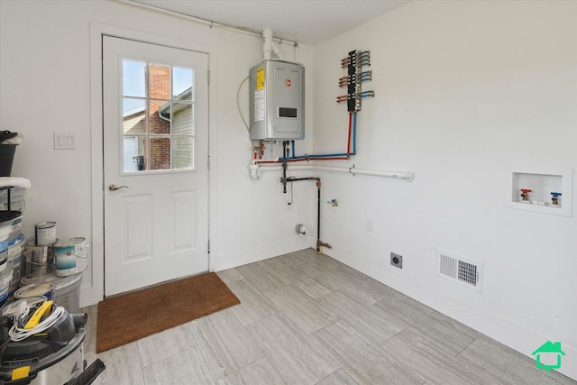 laundry room featuring laundry area, visible vents, water heater, washer hookup, and electric dryer hookup