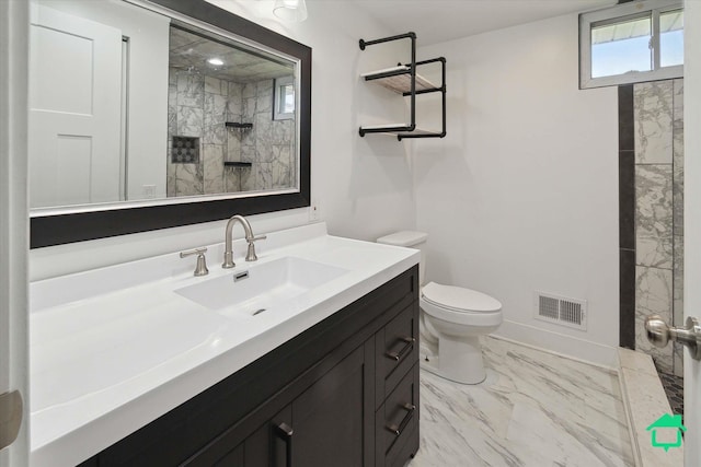 full bathroom featuring visible vents, toilet, marble finish floor, a tile shower, and vanity