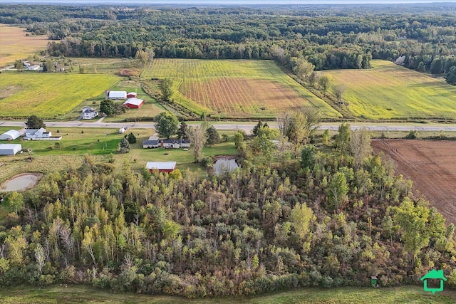 birds eye view of property with a wooded view and a rural view