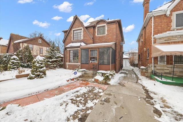 view of front of property featuring a sunroom and brick siding