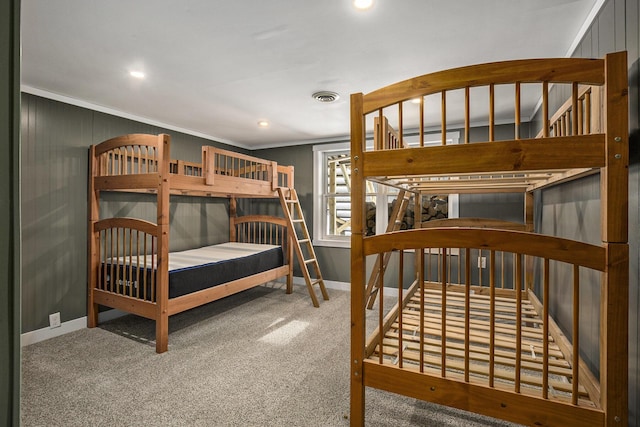 carpeted bedroom with ornamental molding