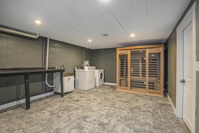 washroom featuring washer and dryer, carpet floors, and sink