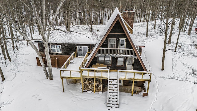 view of snow covered back of property