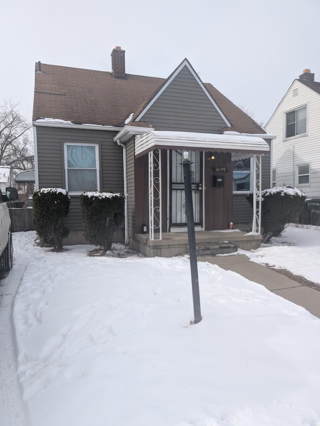 view of snow covered back of property