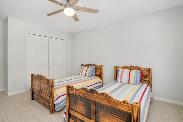 bedroom featuring a closet, ceiling fan, and light colored carpet