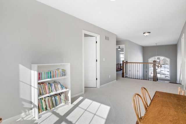 interior space featuring ceiling fan and light carpet