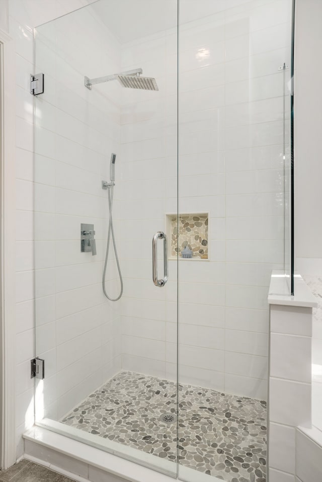 bathroom with a shower with door