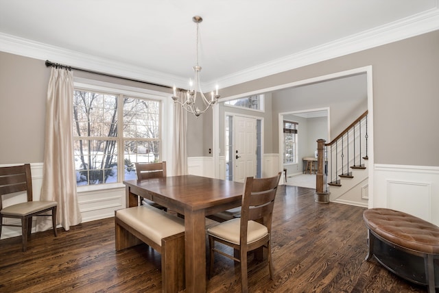 dining space featuring a notable chandelier, crown molding, and dark hardwood / wood-style floors