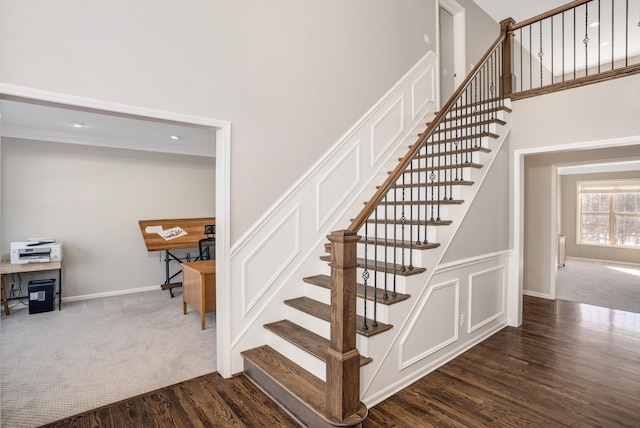 stairway featuring carpet floors and a towering ceiling