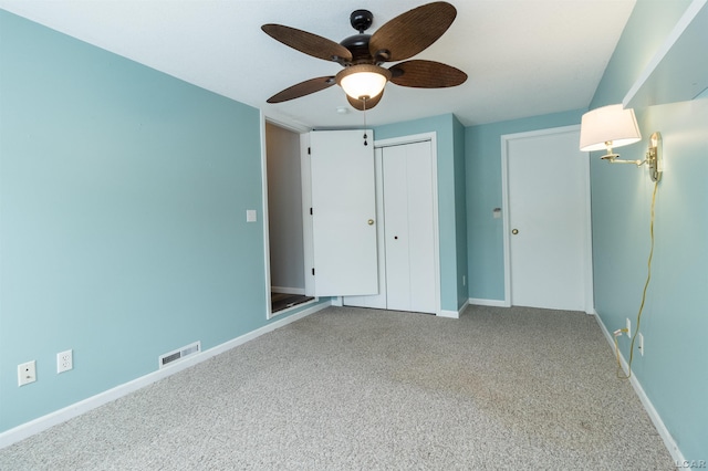 unfurnished bedroom featuring carpet, a closet, and ceiling fan