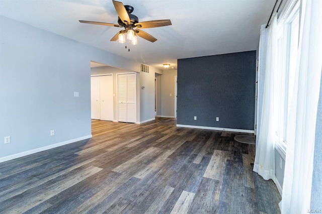 spare room featuring ceiling fan and dark hardwood / wood-style floors