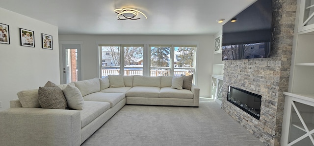 living room with a large fireplace, carpet, and built in features