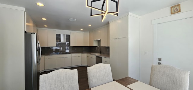 kitchen featuring tasteful backsplash, wall chimney exhaust hood, black appliances, dark hardwood / wood-style flooring, and sink