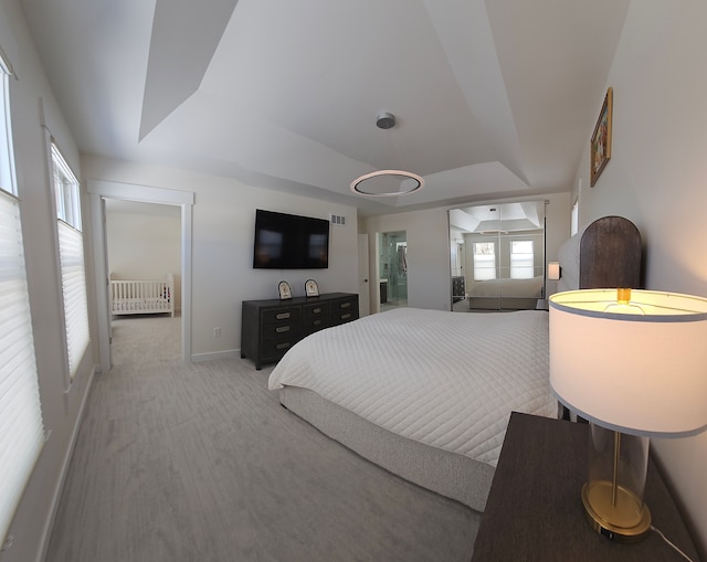 carpeted bedroom featuring a tray ceiling and radiator