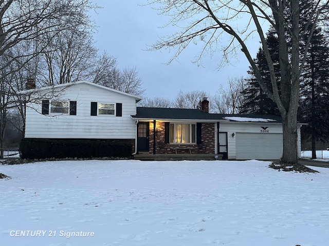 split level home featuring a garage and cooling unit