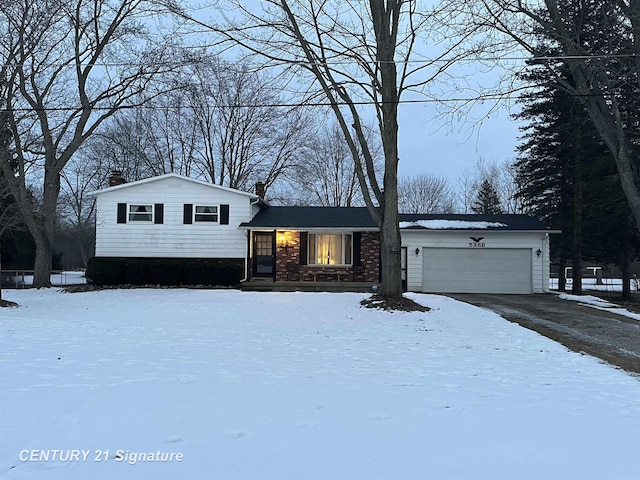 tri-level home with driveway and an attached garage