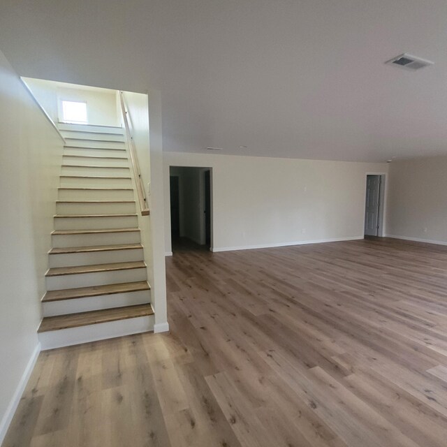 10781 Woodbrook Dr, Cement City, MI 49233 - stairs with wood finished floors