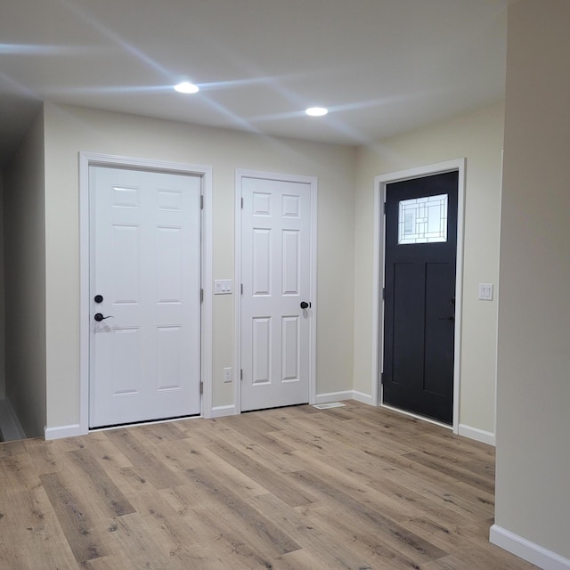 10781 Woodbrook Dr, Cement City, MI 49233 - entryway with light wood-type flooring and recessed lighting
