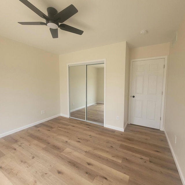 10781 Woodbrook Dr, Cement City, MI 49233 - unfurnished bedroom featuring wood finished floors, a closet, and a ceiling fan