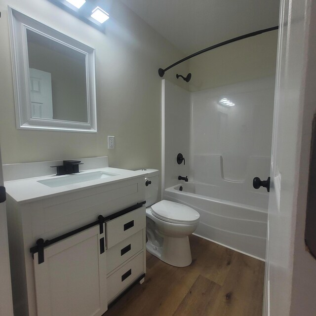 10781 Woodbrook Dr, Cement City, MI 49233 - full bath featuring wood finished floors, vanity, and shower / washtub combination