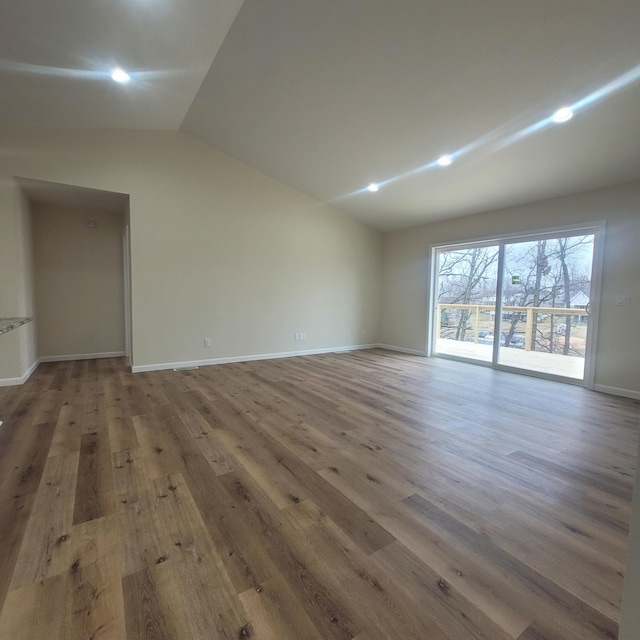 10781 Woodbrook Dr, Cement City, MI 49233 - empty room with lofted ceiling, wood finished floors, and recessed lighting
