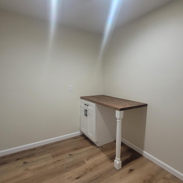 10781 Woodbrook Dr, Cement City, MI 49233 - laundry area with light wood-style flooring and baseboards