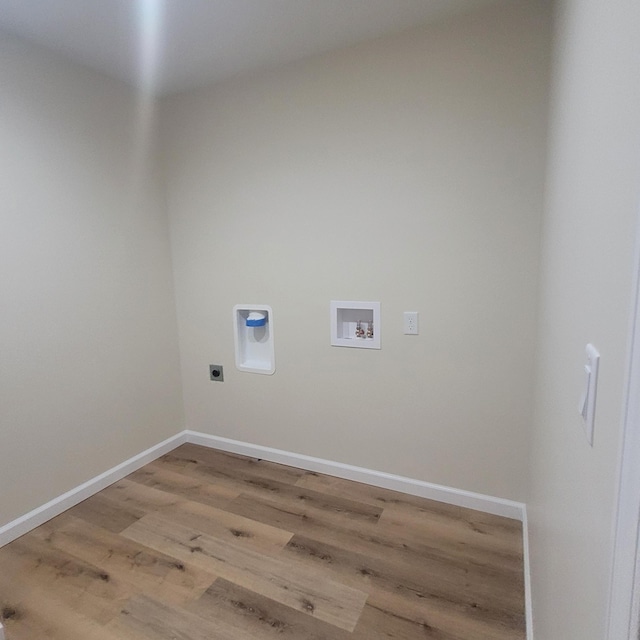 10781 Woodbrook Dr, Cement City, MI 49233 - washroom with electric dryer hookup, washer hookup, and light wood-style floors