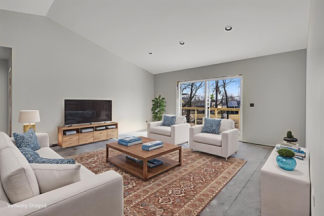 10781 Woodbrook Dr, Cement City, MI 49233 - living room featuring concrete flooring, vaulted ceiling, and recessed lighting