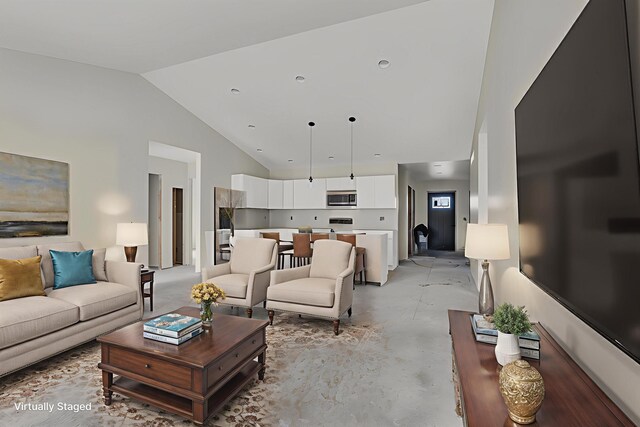 10781 Woodbrook Dr, Cement City, MI 49233 - living area featuring concrete flooring and high vaulted ceiling