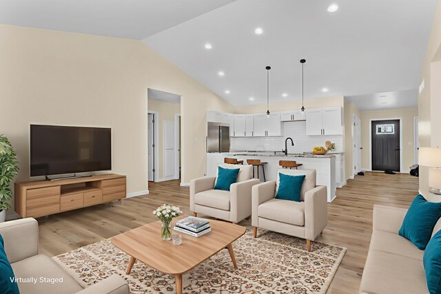 10781 Woodbrook Dr, Cement City, MI 49233 - living room featuring recessed lighting, light wood-type flooring, and lofted ceiling