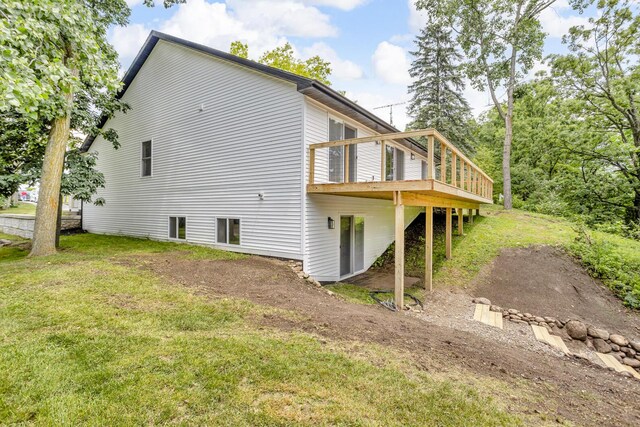 10781 Woodbrook Dr, Cement City, MI 49233 - view of side of property featuring a wooden deck and a lawn