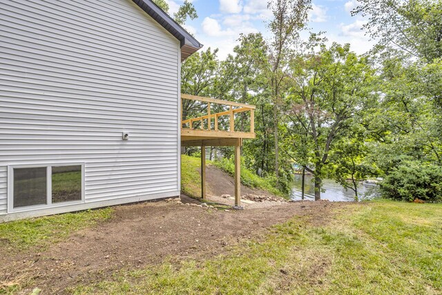 10781 Woodbrook Dr, Cement City, MI 49233 - view of green lawn with a deck with water view